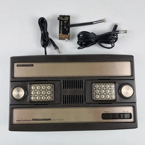 “Mattel Intellivision console with controllers and overlays – Retros.ae”