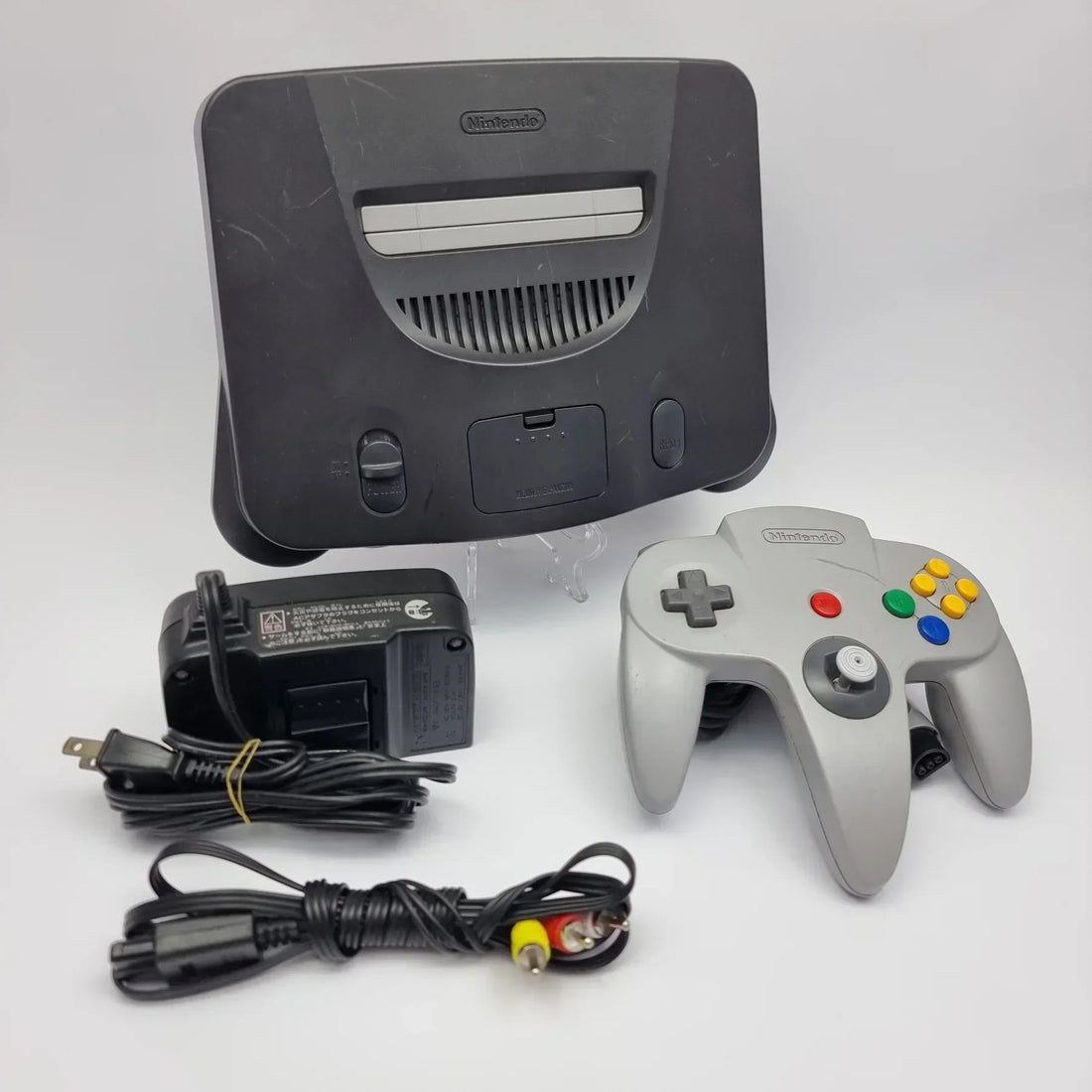Nintendo 64 console with controller on white background