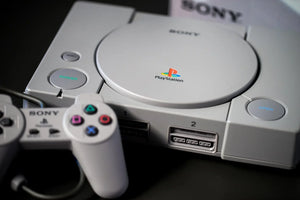 PlayStation 1 console with controller and cables