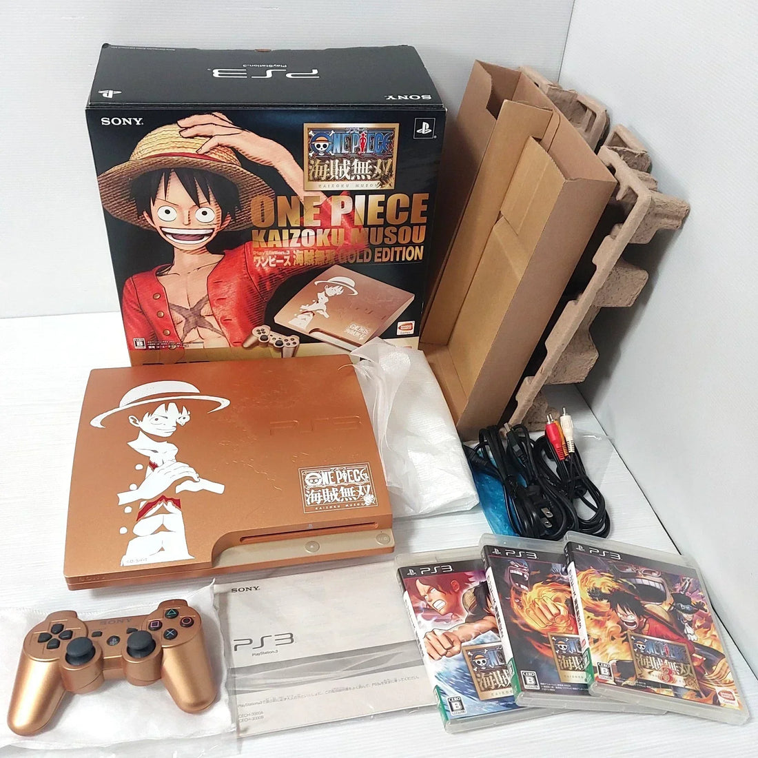 Complete-in-box PS3 One Piece Kaizoku Musou Gold Edition with console, controller, and original packaging