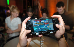 Sony PSP handheld console with physical UMD games displayed as a retro gaming collection in 2026