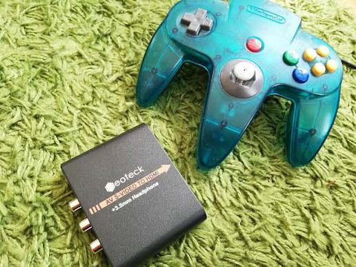 Retro gaming consoles connected to a modern 4K TV using HDMI adapters, converters and video scalers in 2026