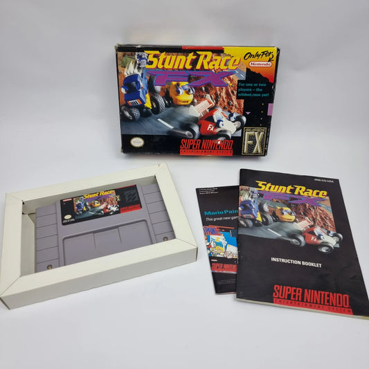 Original retro gaming instruction manuals displayed with classic cartridges, game cases, boxes, and Complete-in-Box video games.