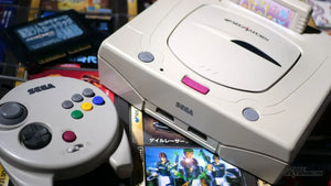 Collector display featuring Sega Saturn consoles and physical game discs