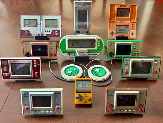 Collection of authentic Japanese retro gaming consoles including Famicom, Super Famicom, Sega Saturn, PlayStation, and PC Engine for collectors.