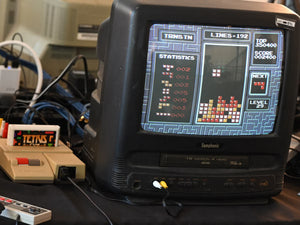 Original retro gaming consoles, physical games, and classic controllers set up for an authentic vintage gaming experience.